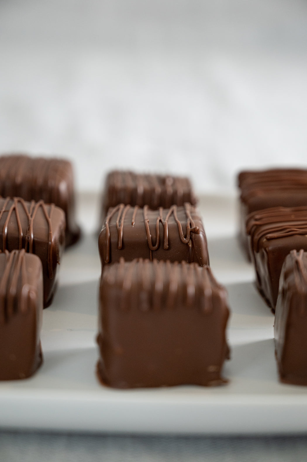 Homemade Dulce de Leche Swirled Marshmallows Dipped in Milk Chocolate.